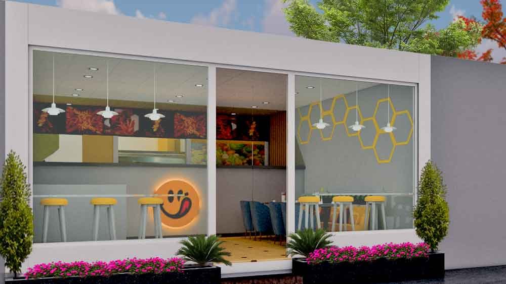 Café storefront glass facade with hexagon wall art and outdoor landscaping