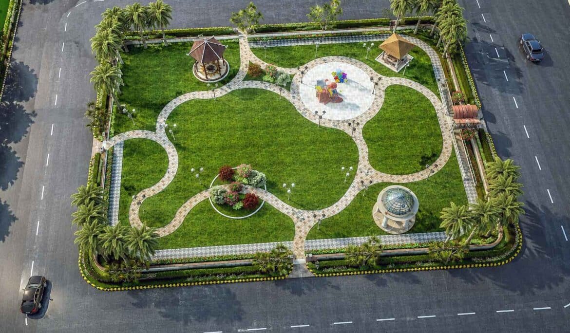 Aerial daytime view of a rectangular community park with curved pathways, two gazebos, a central play area, and palm trees along the boundary.