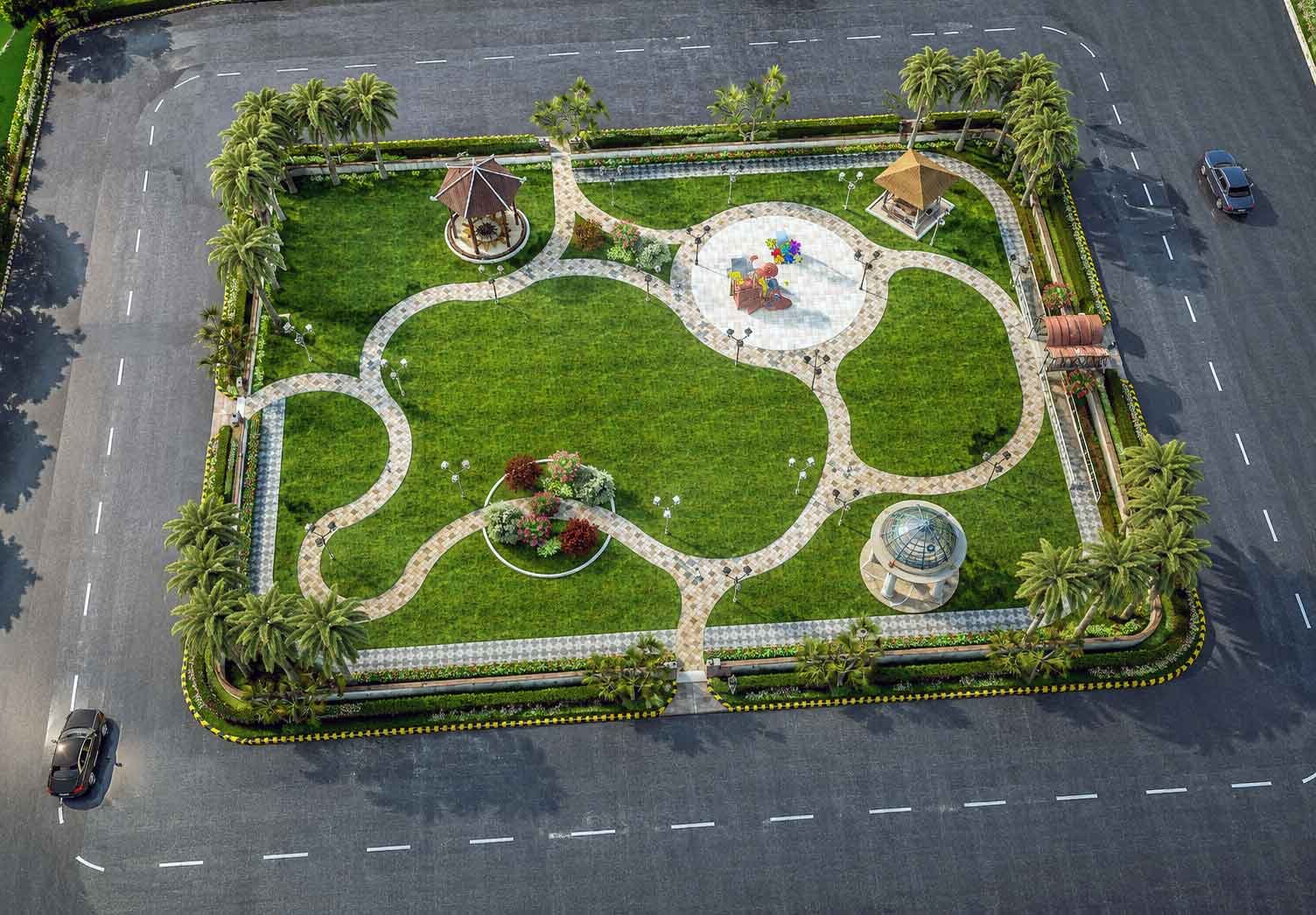 Aerial daytime view of a rectangular community park with curved pathways, two gazebos, a central play area, and palm trees along the boundary.