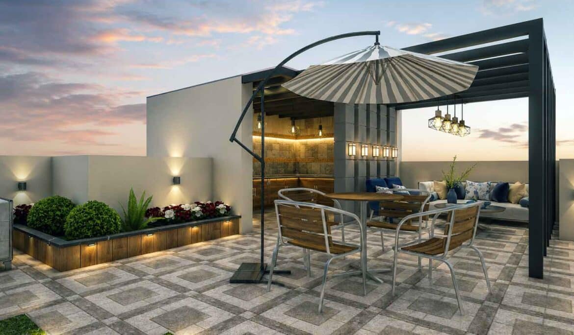 Rooftop terrace design with pergola, dining set, striped umbrella, and outdoor kitchen at sunset