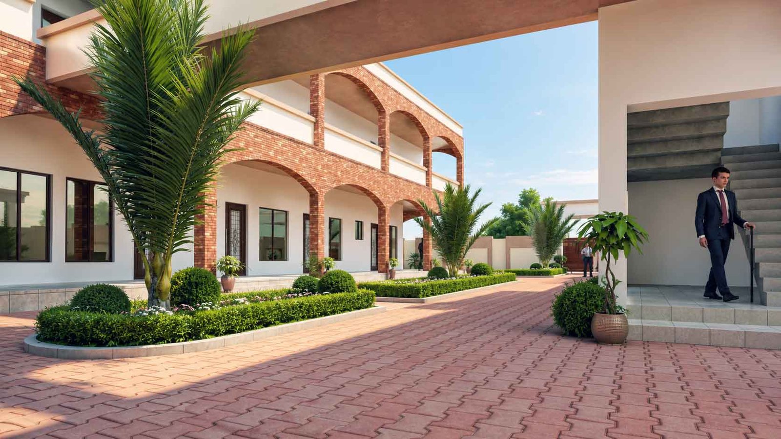School building courtyard with brick arches, palm trees, and manicured garden beds